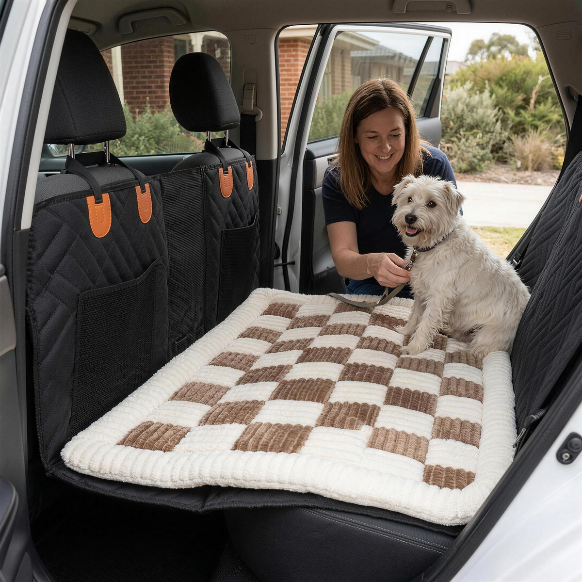 woman clipping a lead onto her terrier sitting on the mypawz plush backseat bed in the car